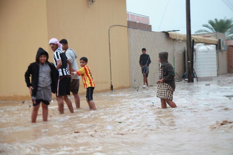 Children play outdoors on waterlogged streets in Ras Al Khaimah. Residents say floods haven't been seen since 1975. Mariam Al Nuaimi / The National