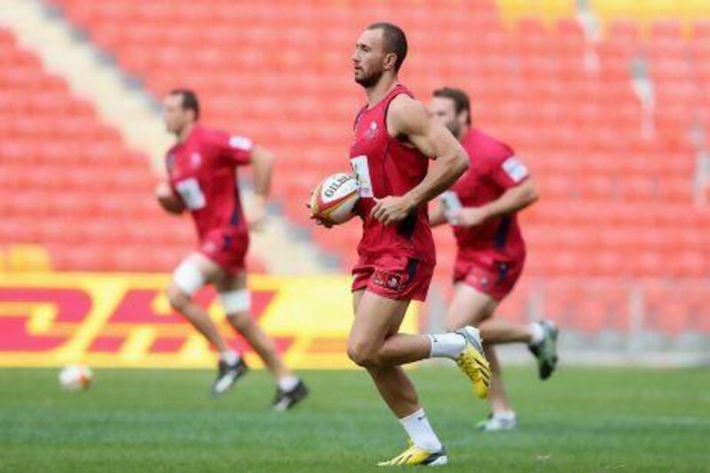 Quade Cooper, centre, will captain Queensland Reds when they face British & Irish Lions in what is likely Cooper's final chance to impress Australia coach Robbie Deans enough to get selected to the team.