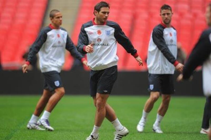 Frank Lampard, who will captain England today, displays his poppy during training at Wembley Stadium yesterday.