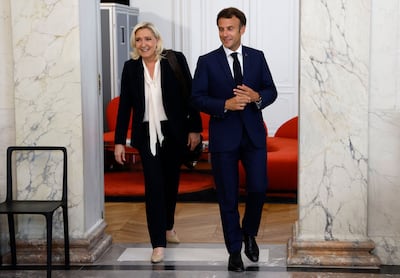 Marine Le Pen is escorted by France's President Emmanuel Macron after talks at the presidential Elysee Palace in Paris, in June. AFP