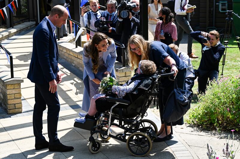 Later in the day Prince William and Kate receive a bunch of flowers from a child during a visit to East Anglia’s Children’s Hospice in Milton. Getty Images