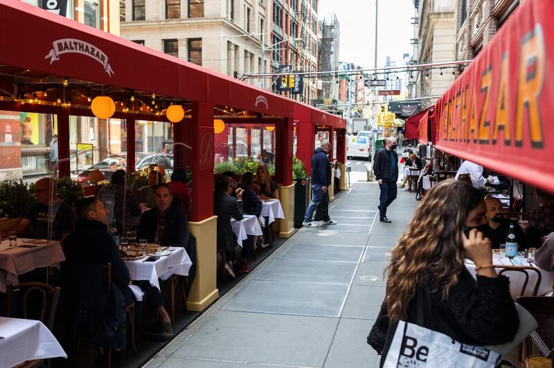 Customers dine outside a restaurant in New York City. The pandemic emptied the city's streets last year, but now some businesses are returning. Bloomberg