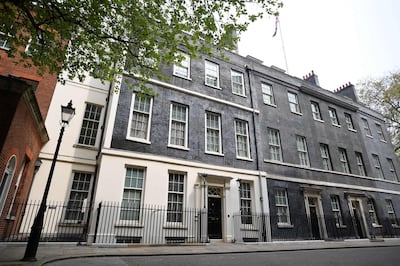 CORRECTION / Numbers 12 (L), 11 (C) and 10 (R) Downing Street are pictured in central London on April 28, 2021. Britain's Electoral Commission on Wednesday announced a formal investigation into how Prime Minister Boris Johnson paid for a lavish makeover of his Downing Street flat, seriously escalating a simmering scandal. Johnson, his fiancee Carrie Symonds and their baby son live in quarters above Number 11 Downing Street, which are more spacious than those attached to Number 10. / AFP / JUSTIN TALLIS
