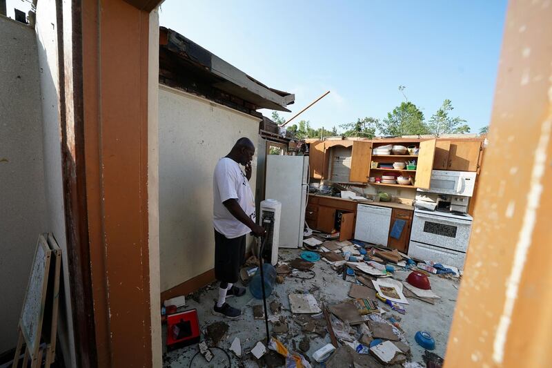 James Jackson smokes a cigarette in what is left of his home following a tornado in Jefferson City. Reuters