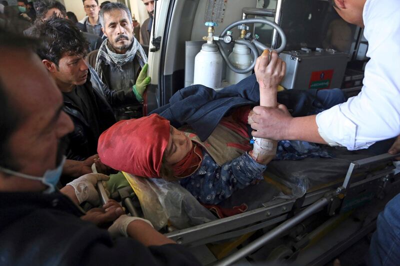People carry an injured woman to hospital. Rahmat Gul / AP Photo