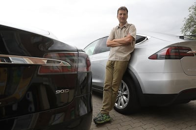 Stefan Moeller, co-founder of Nextmove, poses for a photograph between a Tesla Inc. Model S, left, and a Tesla Inc. Model X electric automobile at the company's headquarters in Leipzig, Germany, on Thursday, Aug. 15, 2019. Moeller began this year with an ambitious target: to make his car-rental company the biggest Tesla Inc. customer in Germany by adding 100 Model 3s to its fleet. Photographer: Krisztian Bocsi/Bloomberg