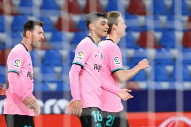Barcelona midfielder Pedri (c) celebrates with Lionel Messi and Frenkie De Jong after scoring against Levante. AFP