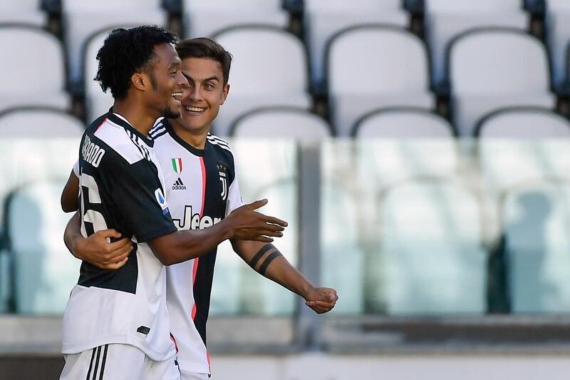 Juventus Juan Cuadrado, left, celebrates with his teammate Paulo Dybala after scoring his side's second. AP