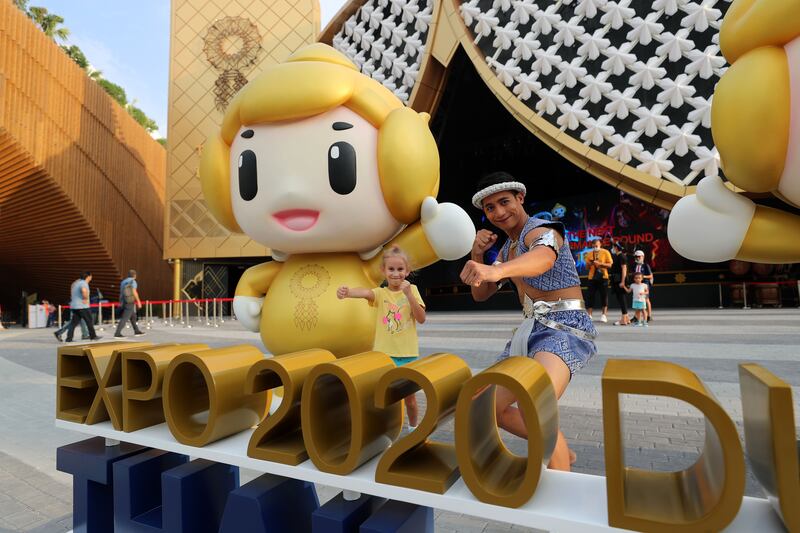 Muay Thai fighter Dong Theeramate with Salma, 6, from Jordan outside the Thailand pavilion