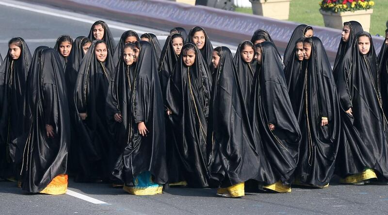 Young Qatari women in traditional dress during the parade.