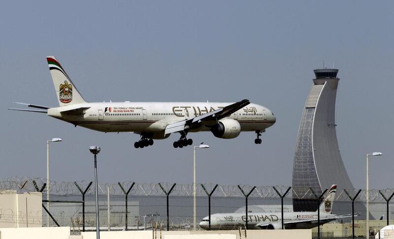 An Etihad Airways plane prepares to land at Abu Dhabi's airport. The carrier is one of the first airlines globally to launch the Iata Travel Pass. AP