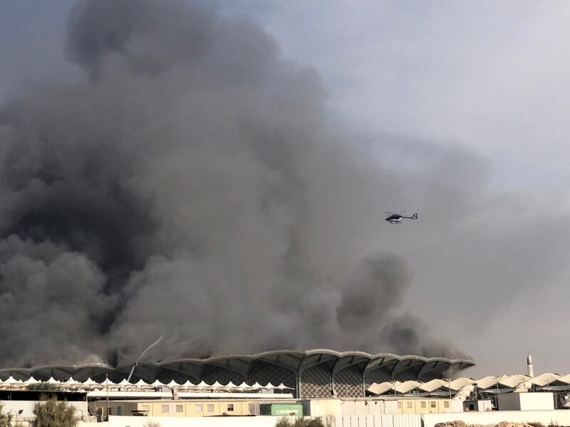 A firefighting helicopter sprays water on the fire at the Haramain high-speed rail station in Jeddah. Reuters