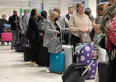 Passengers queue for check-in at Manchester Airport on Tuesday morning. Getty Images
