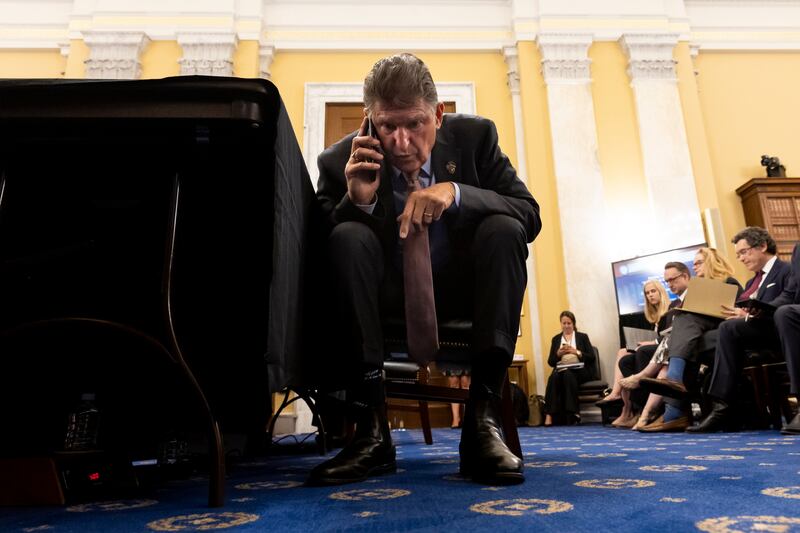 West Virginia Democratic senator Joe Manchin takes a call moments before appearing at the Senate Rules and Administration hearing to examine the Electoral Count Act, on Capitol Hill in Washington. EPA