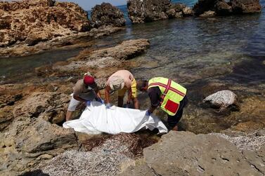 File Photo: Rescue workers recover the dead bodies of migrants on a beach in the coastal suburb of Tajoura, east of Tripoli, Libya August 3, 2020 Reuters