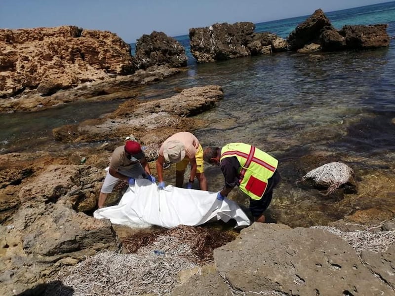 ATTENTION EDITORS - SENSITIVE MATERIAL. THIS IMAGE MAY OFFEND OR DISTURB  Rescue workers recover the dead bodies of migrants on a beach in the coastal suburb of Tajoura, east of Tripoli, Libya August 3, 2020. Picture taken August 3, 2020. REUTERS/Mahmoud Ali Mohamed  NO RESALES. NO ARCHIVES