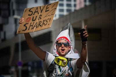 An Ocean Rebellion activist holds a banner reading 'Save our sharks' during a protest in Lisbon, Portugal. AFP