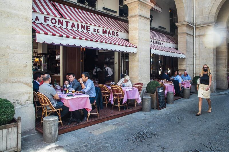 People relax on the terrace of the 'La Fontaine de Mars' restaurant in Paris. EPA