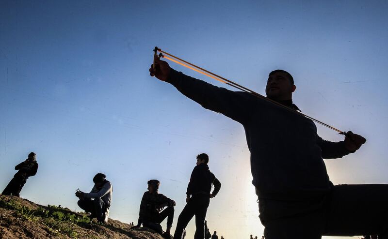 A Palestinian protester uses a slingshot to hurl objects during clashes following a demonstration in Gaza City. AFP