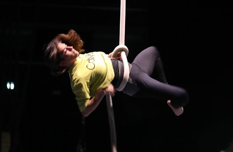 A rope artist training backstage