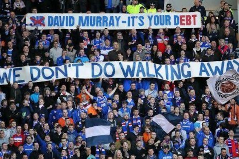 Rangers fans display banners during the a Scottish Premier League match at Ibrox Stadium, Glasgow. PA