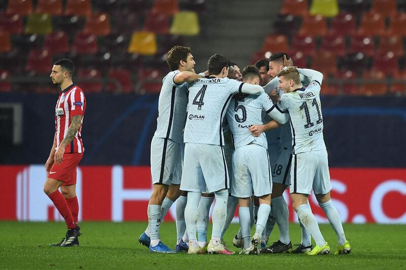 Chelsea's French striker Olivier Giroud (2R) celebrates with teammates after scoring during UEFA Champions League round of 16 first leg football match between Club Atletico de Madrid and Chelsea at the Arena Nationala stadium in Bucharest on February 23, 2021. (Photo by Daniel MIHAILESCU / AFP)