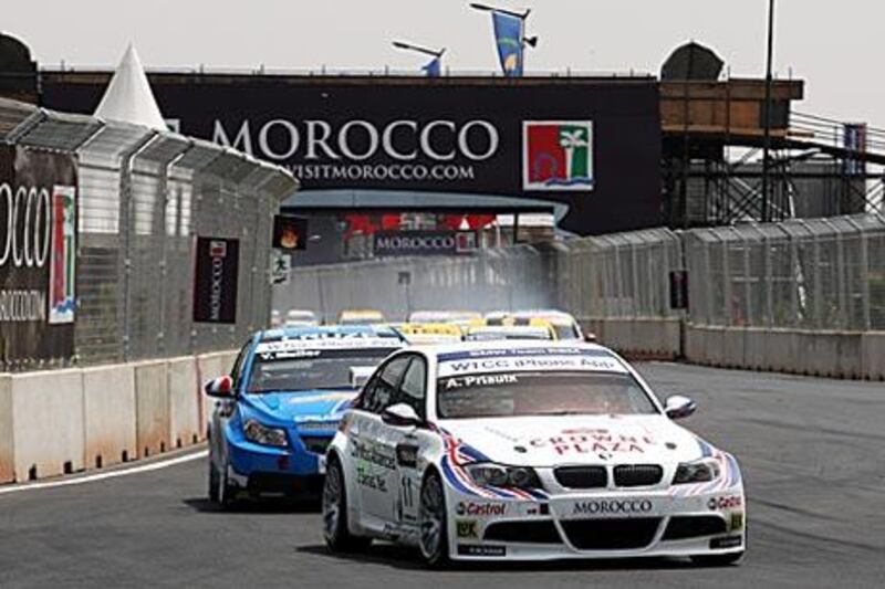 Andy Priaulx holds off Yvan Muller in Marrakech yesterday to take victory.