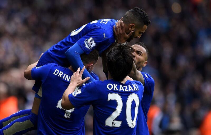 Leicester City players celebrate with Riyad Mahrez after he opened the scoring against Swansea City. Mike Hewitt / Getty Images