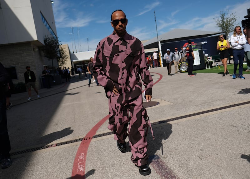 Lewis Hamilton, in a patterned Louis Vuitton two-piece, arrives at the US Grand Prix in Austin, Texas, on October 22, 2022. Reuters