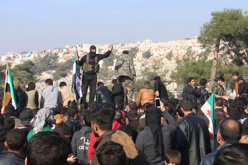 In this frame grab from video militants of the Al Qaida-linked Hayat Tahrir al-Sham try to disperse people who have gathered at the Bab al-Hawa border gate to protest the ongoing bombing campaign in Syria's rebel-controlled Idlib province by the government and its Russian ally. AP Photo