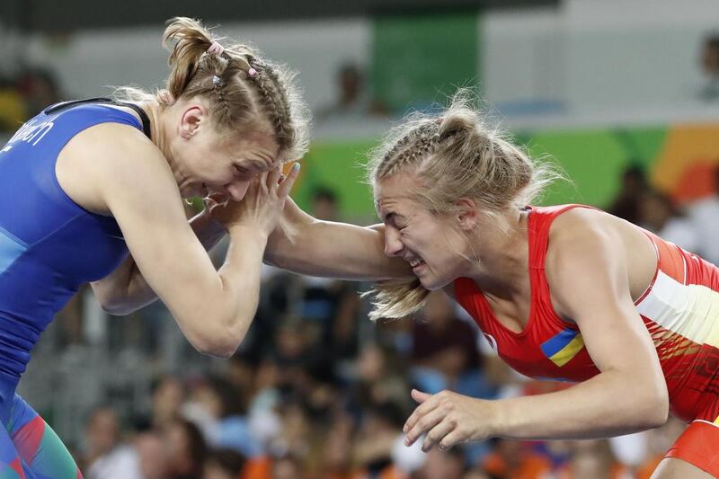 Ukraine’s Oksana Herhel (red) competes with Azerbaijan’s Yuliya Ratkevich (blue) during her women’s wrestling 58kg freestyle qualification match. Jack Guez / AFP