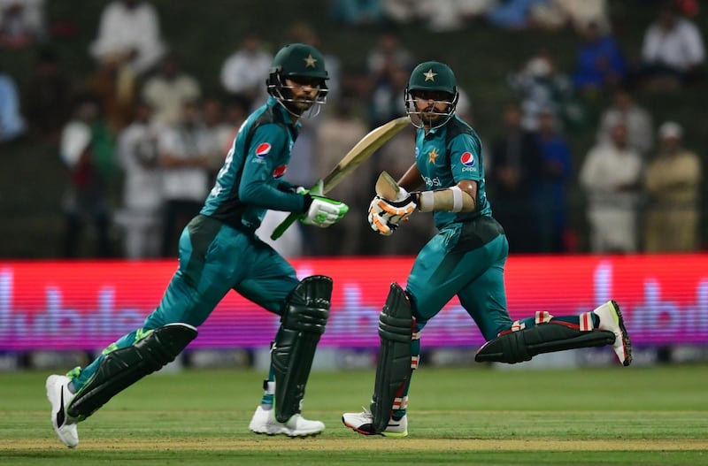 Pakistan cricketer Fakhar Zaman (L) and Pakistan cricketer Babar Azam run between the wickets   during the second one day international (ODI) cricket match between Pakistan and New Zealand at The Sheikh Zayed Cricket Stadium in Abu Dhabi on November 9, 2018.  / AFP / GIUSEPPE CACACE
