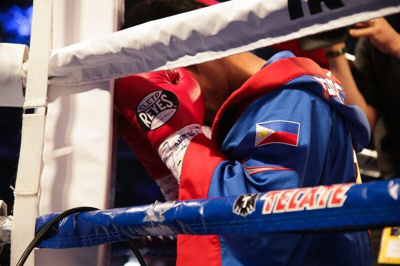 Pacquiao prepares himself mentally in a corner before the start of his fight with American Brandon Rios. Nicky Loh / Getty Images