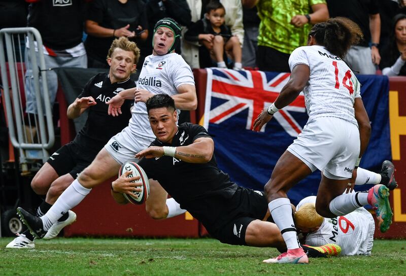 Quinn Tupaea of the All Blacks is tackled by Nick Civetta of the Eagles. AFP