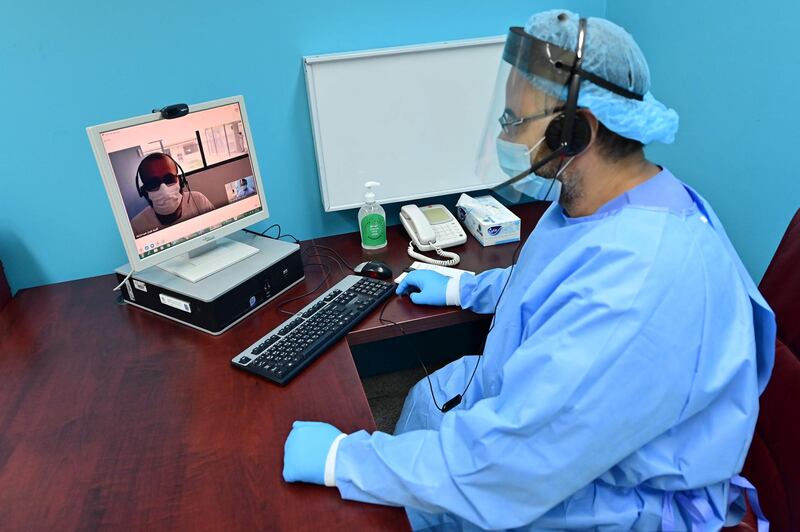 A doctor speaks remotely to an inmate in another part of the jail
