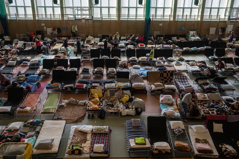 People who fled the war in Ukraine rest inside an indoor sports stadium being used as a refugee centre in the village of Medyka in Poland. AP