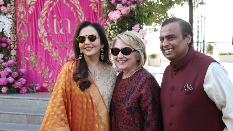 Former U.S. Secretary of State Hillary Clinton poses with Mukesh Ambani, Chairman of Reliance Industries, and his wife Nita Ambani after her arrival in Udaipur to attend pre-wedding celebrations of their daughter Isha Ambani in the desert state of Rajasthan, India, December 8, 2018. Reliance Industries/Handout via REUTERS  ATTENTION EDITORS - THIS IMAGE WAS PROVIDED BY A THIRD PARTY. NO RESALES. NO ARCHIVE.