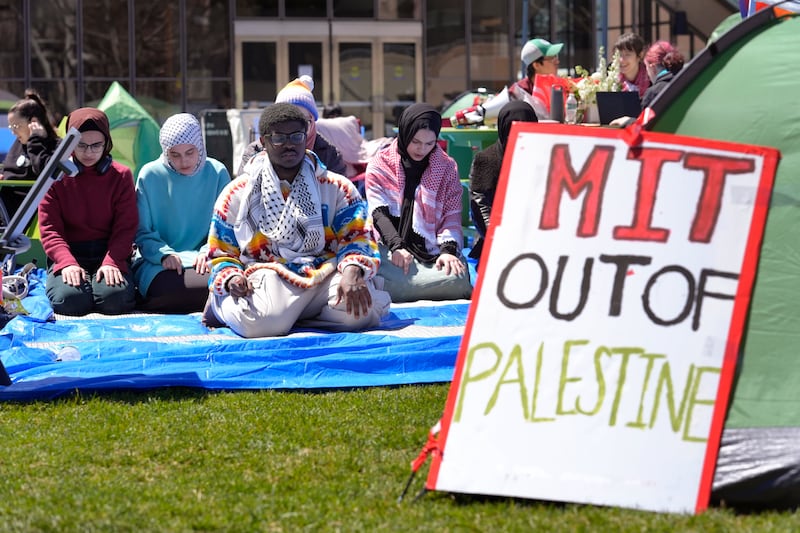 Massachusetts Institute of Technology student Isa Liggans,  front left, takes part in Muslim prayer with others, at an encampment of tents at the college, in Cambridge, Massachusetts.  AP