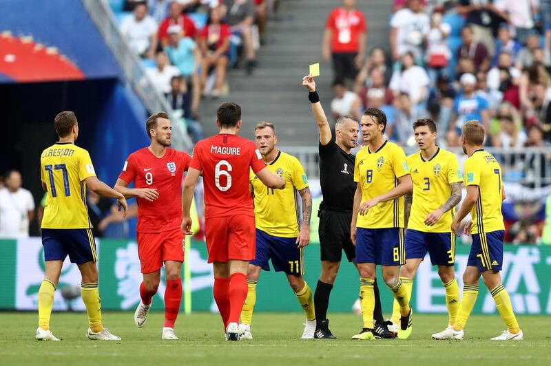 SAMARA, RUSSIA - JULY 07:  John Guidetti of Sweden and Harry Maguire of England receive a yellow card from Referee Bjorn Kuipers during the 2018 FIFA World Cup Russia Quarter Final match between Sweden and England at Samara Arena on July 7, 2018 in Samara, Russia.  (Photo by Ryan Pierse/Getty Images)