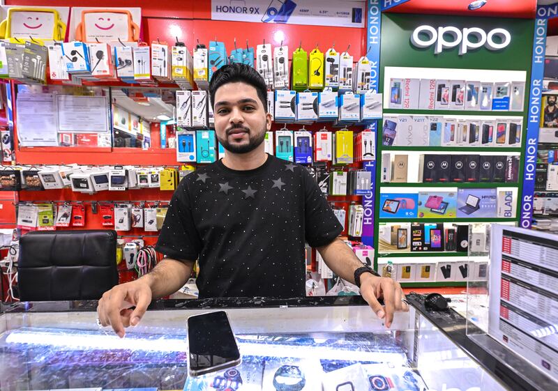 Anas Anzy, 24, who studied mobile technology at the University of Kerala in India, works at his father's shop Cellpark