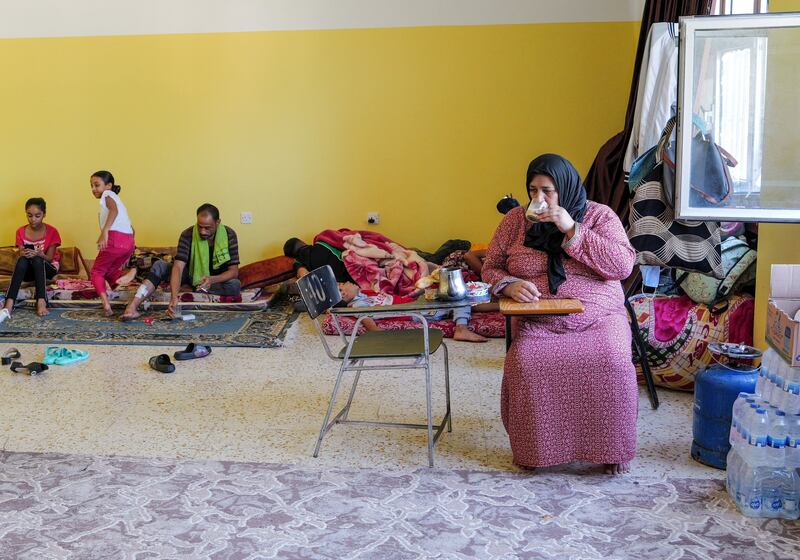 A Palestinian woman who survived the deadly storm eats breakfast in a classroom at Derna's College of Medical Technology. Reuters
