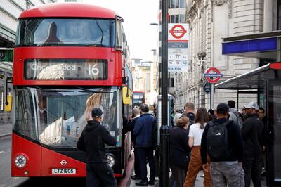 Passengers board a bus outside Victoria Station, in central London. Reuters