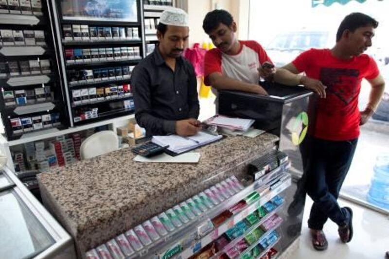 Abu Dhabi, United Arab Emirates, May 4, 2013:    Manager Khatim Jibran, center, at the Eid Grocery where they suffered 3,000 Dhs in damage when vandals broke their front window near the Eid Prayer ground in Abu Dhabi on May 4, 2013. Christopher Pike / The National