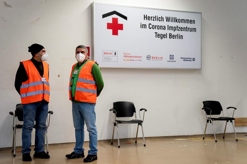 People stand at a newly-opened vaccination centre for AstraZeneca's vaccine at Berlin's former Tegel airport. Reuters