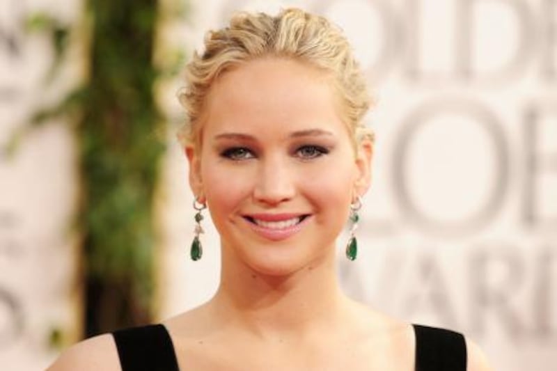 Actress Jennifer Lawrence arrives on the red carpet for the 68th annual Golden Globe awards at the Beverly Hilton Hotel in Beverly Hills, California January 16, 2011.  AFP PHOTO  / Robyn Beck