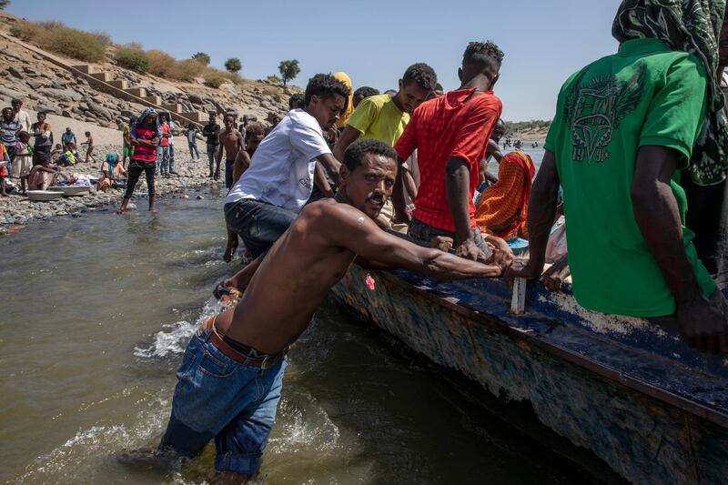 Tigray refugees who fled the conflict in the Ethiopia's Tigray ride a boat on the banks of the Tekeze River on the Sudan-Ethiopia border, in Hamdayet, eastern Sudan. AP Photo