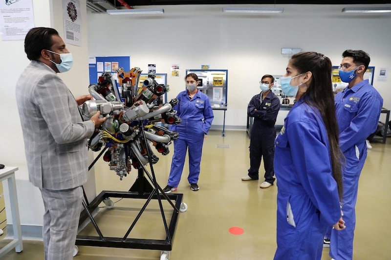 DUBAI, UNITED ARAB EMIRATES , September 21 – 2020 :- Sarath Raj, Programme Leader, Aerospace Engineering (left) explaining to the Aerospace Science students about the Radial Engine at the Aerospace Lab at the Amity University in Academic City in Dubai.  (Pawan Singh / The National) For News. Story by Sarwat