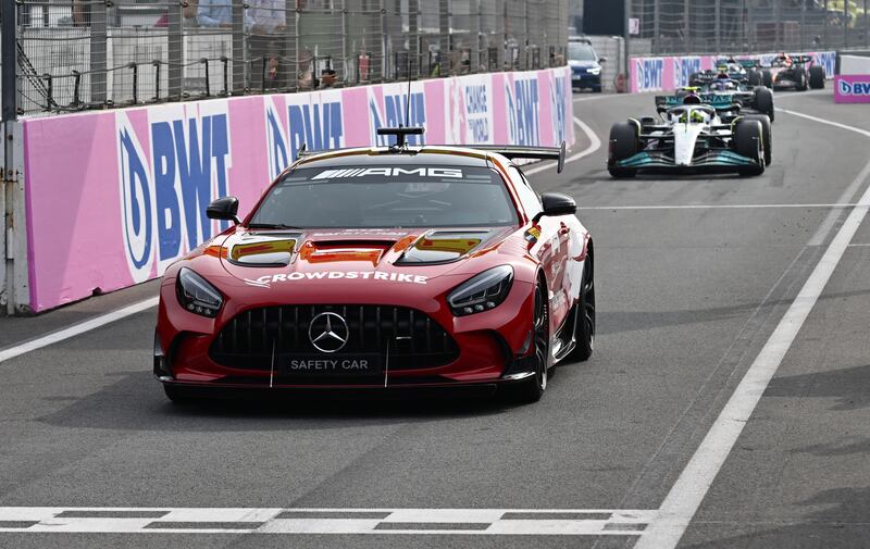 The safety car leads Mercedes' Lewis Hamilton and the field through the pit lane. Reuters