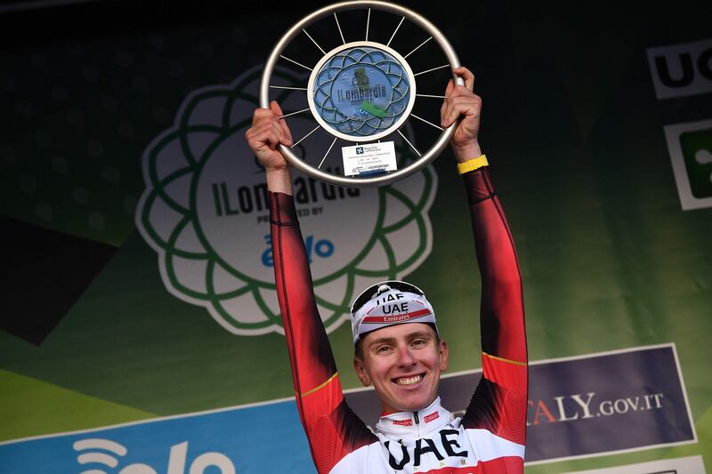 Tadej Pogacar celebrates on podium after his win. AFP