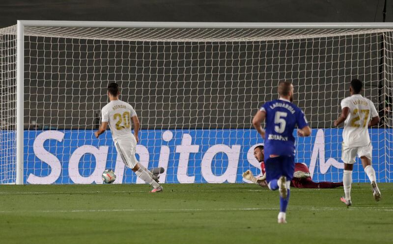 Marco Asensio, left, scores the second goal, AP